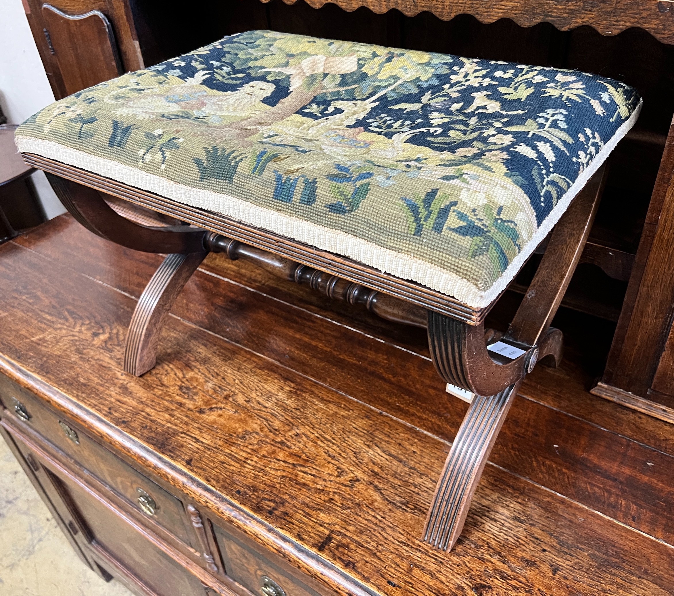 A Regency style mahogany X framed stool, upholstered with a fragment of 17th century Aubusson tapestry, height 40cm